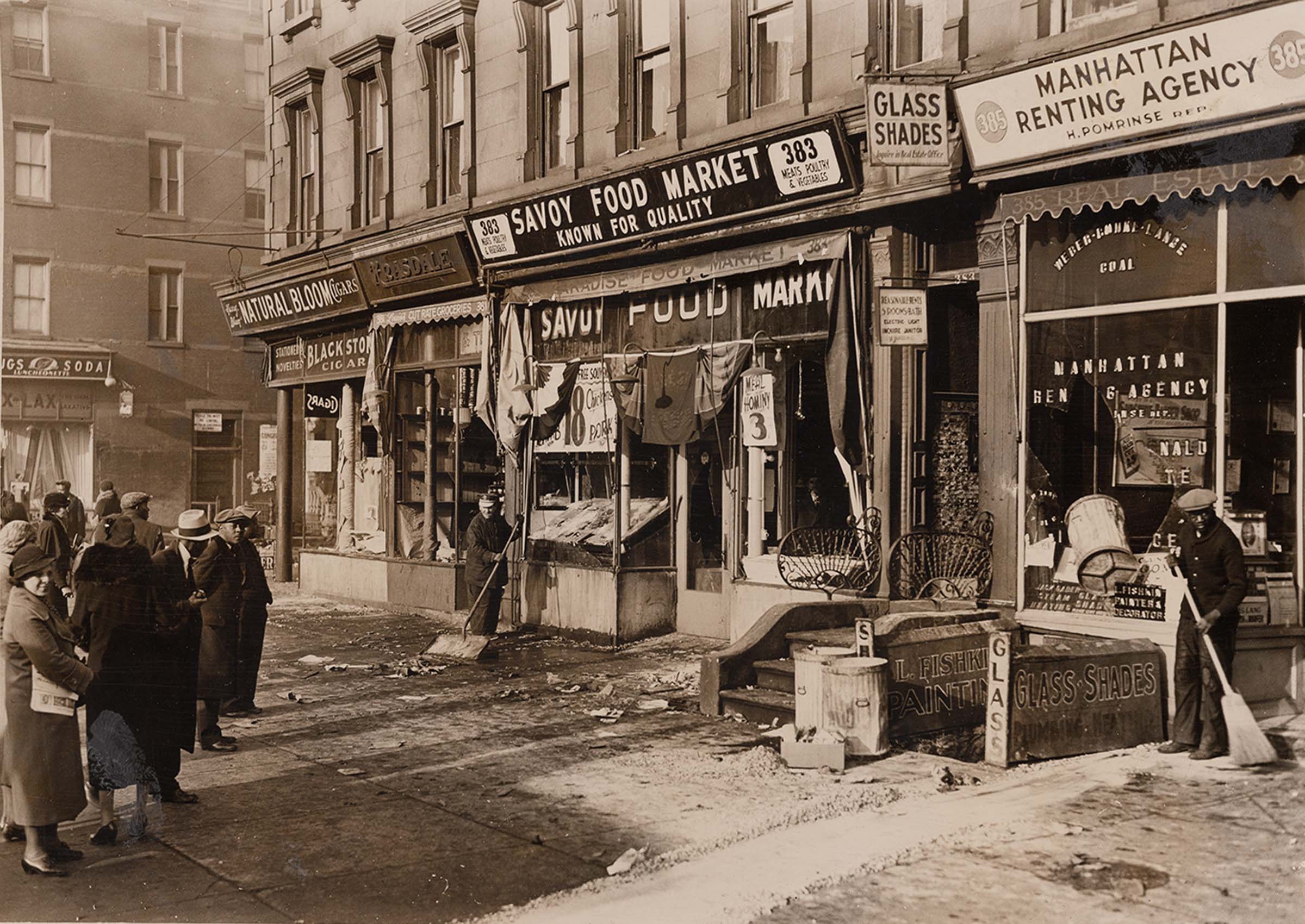 Crowd assessing the damage to storefronts after the riot.